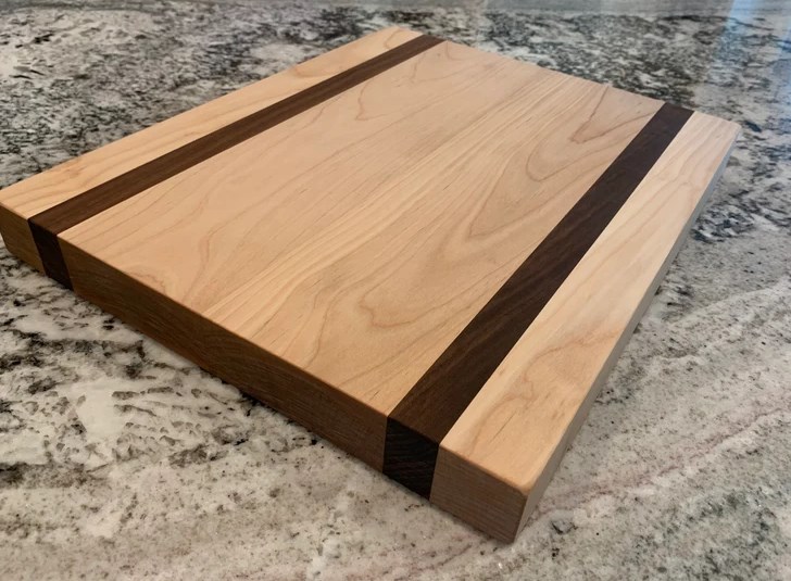 wooden cutting board with two dark stained stripes